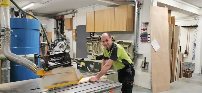 Otti Roos, Gründer und Schreiner, an der Tischkreissäge in der Werkstatt